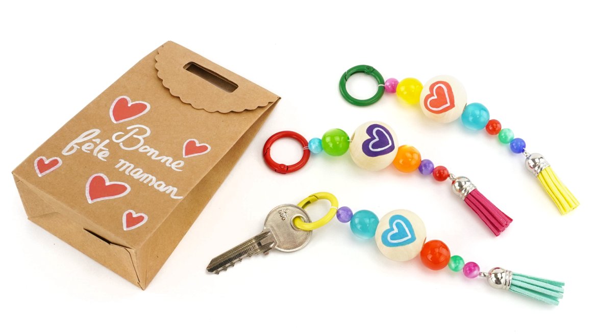 Fabriquez un joli porte-clés coloré à offrir pour la fête des mères avec des perles, pompons et feutres ! Une activité facile dès 3 ans.