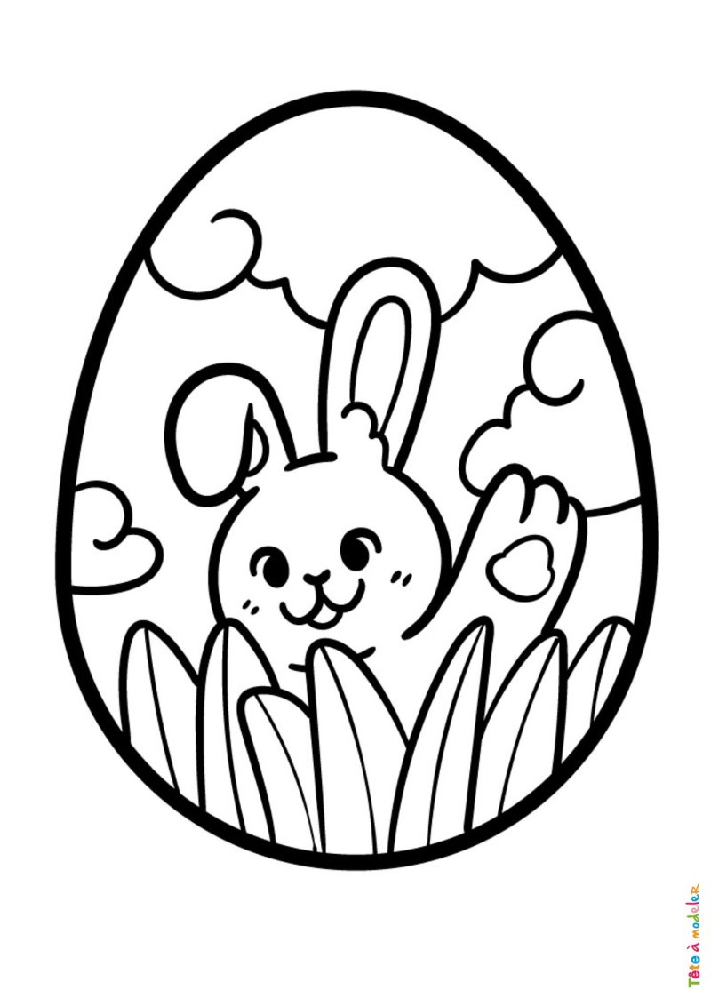 Coloriage d'un petit lapin dans l'herbe sur un oeuf