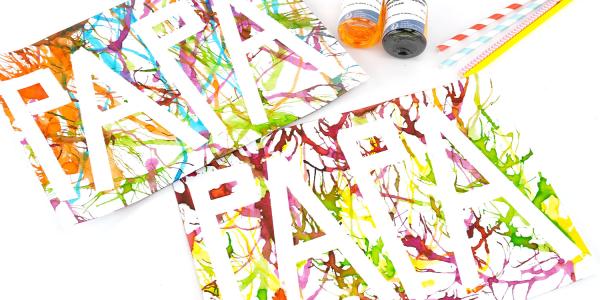 Réalisez un dessin coloré pour la fête des pères avec la peinture soufflée. Une activité facile dès 3 ans avec masking tape et paille.