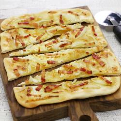 Recette de la flammekueche, la tarte flambée alsacienne. Cette recette de flammekueche est à base de crème fraîche et de fromage blanc. La flammekueche est l'occasion de cuisiner avec les enfants et d